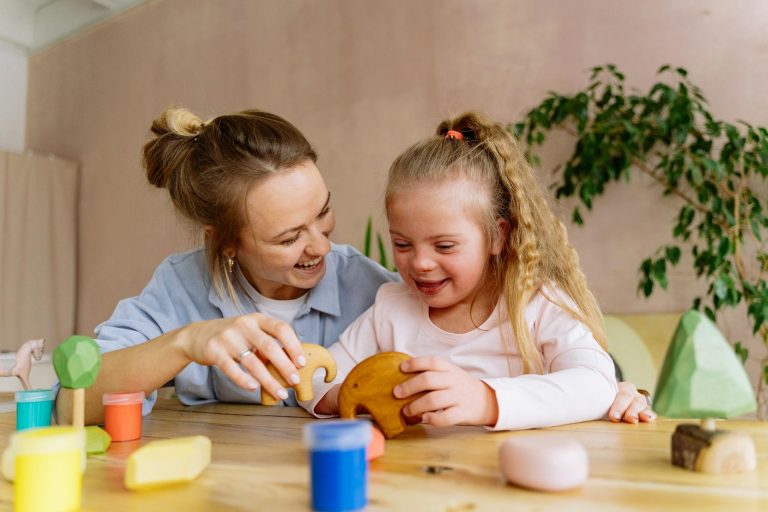 woman and child playing with wooden toys